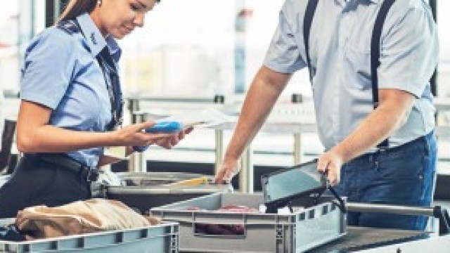 2 security staff check hand luggage